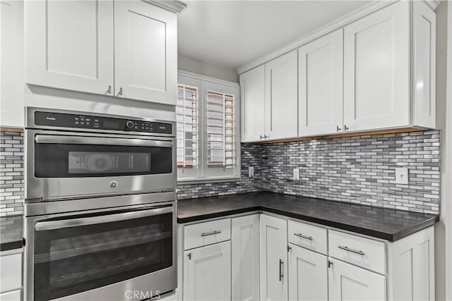 15439 Studebaker Rd, Norwalk, CA 90650 - kitchen with stainless steel double oven, dark countertops, backsplash, and white cabinets