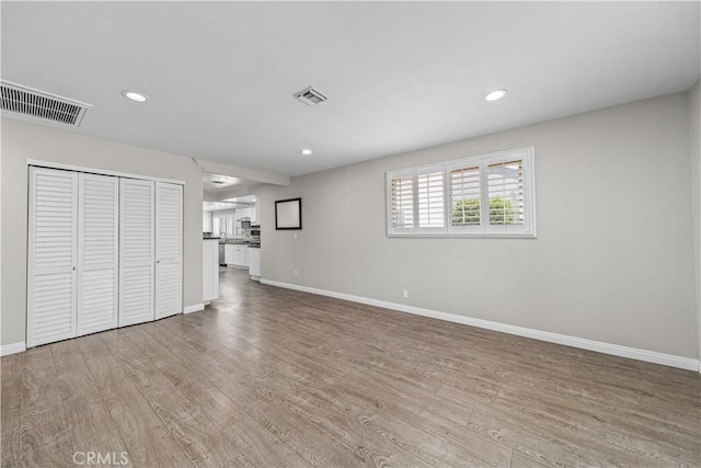 15439 Studebaker Rd, Norwalk, CA 90650 - unfurnished living room with baseboards, wood finished floors, and recessed lighting