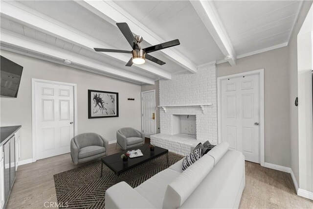 15439 Studebaker Rd, Norwalk, CA 90650 - living room featuring light wood finished floors, ceiling fan, baseboards, a fireplace, and beam ceiling
