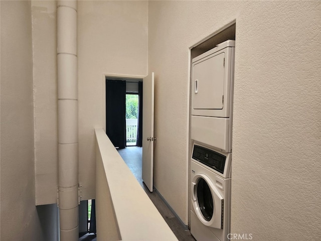 2220 E Chapman Ave Unit 51, Fullerton, CA 92831 - washroom with stacked washer and clothes dryer, a textured wall, and dark wood-style flooring