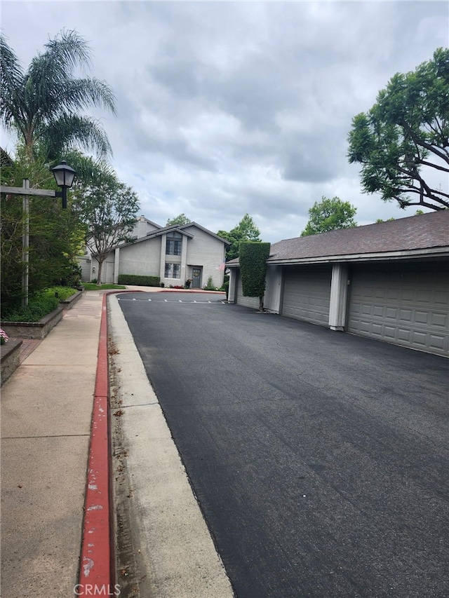 2220 E Chapman Ave Unit 51, Fullerton, CA 92831 - view of asphalt road with community garages and street lighting
