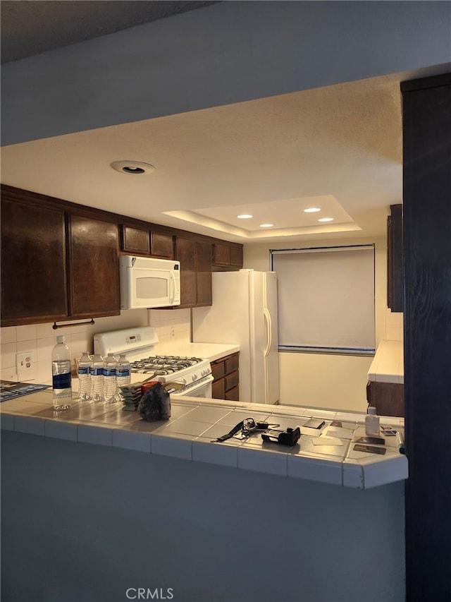 2220 E Chapman Ave Unit 51, Fullerton, CA 92831 - kitchen with white appliances, tile countertops, dark brown cabinetry, recessed lighting, and decorative backsplash