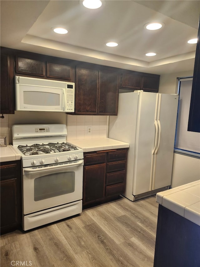 2220 E Chapman Ave Unit 51, Fullerton, CA 92831 - kitchen with white appliances, a raised ceiling, light wood-style flooring, tile countertops, and recessed lighting