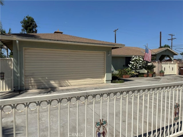 14104 Barrydale St, La Puente, CA 91746 - view of front facade with stucco siding, a garage, and a shingled roof