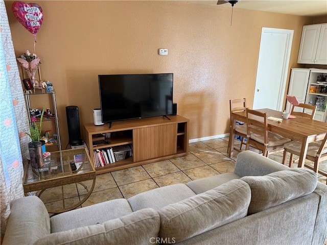 14104 Barrydale St, La Puente, CA 91746 - living area with light tile patterned floors, baseboards, ceiling fan, and a textured wall