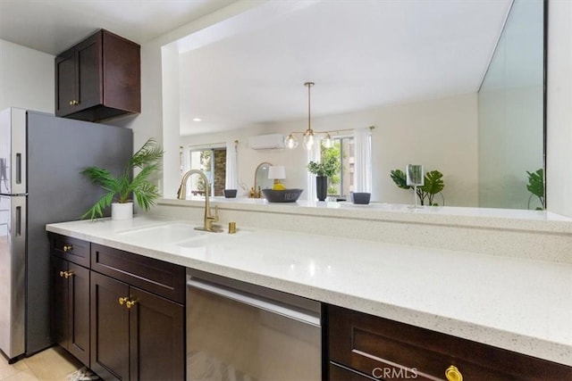 kitchen with appliances with stainless steel finishes, a sink, a wall unit AC, dark brown cabinets, and light stone countertops