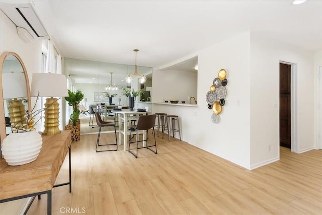 dining room featuring light wood-type flooring and baseboards