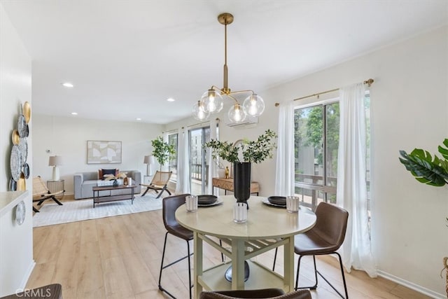 dining room with plenty of natural light, light wood-type flooring, a chandelier, recessed lighting, and baseboards