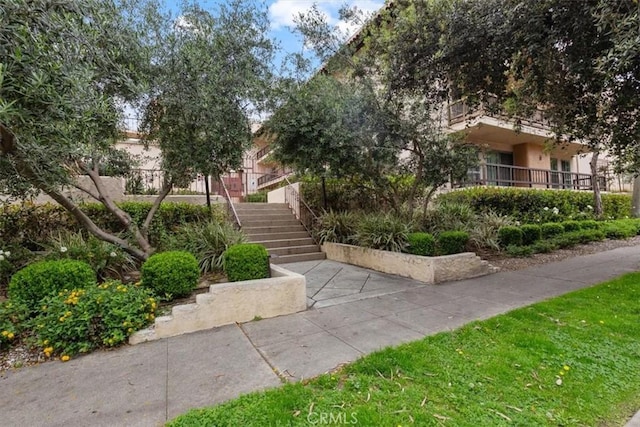 view of front of house featuring stairway and stucco siding