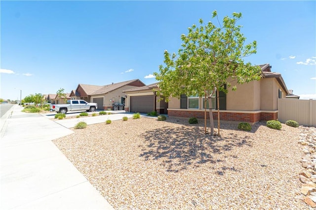 2044 E Lingard St, Lancaster, CA 93535 - view of front of house with an attached garage, concrete driveway, stucco siding, and fence