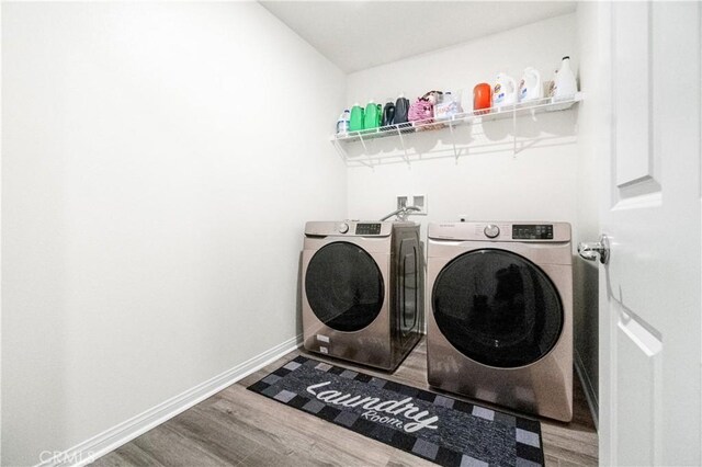 2044 E Lingard St, Lancaster, CA 93535 - laundry area with wood finished floors, washing machine and clothes dryer, and baseboards