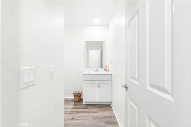 2044 E Lingard St, Lancaster, CA 93535 - bathroom featuring wood finished floors, vanity, baseboards, and recessed lighting