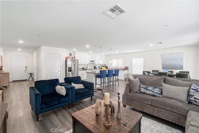 2044 E Lingard St, Lancaster, CA 93535 - living room featuring light wood-type flooring and recessed lighting