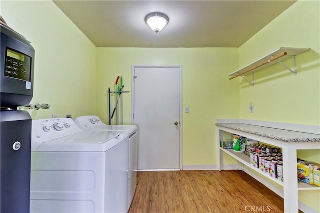 27930 Lexington Ct, Menifee, CA 92586 - laundry area with independent washer and dryer, wood finished floors, and baseboards