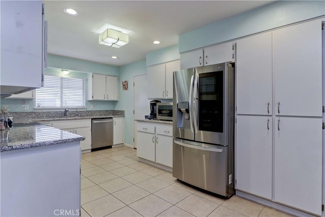 27930 Lexington Ct, Menifee, CA 92586 - kitchen featuring stainless steel appliances, light tile patterned floors, white cabinets, light stone countertops, and a sink