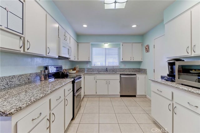 27930 Lexington Ct, Menifee, CA 92586 - kitchen with appliances with stainless steel finishes, a sink, white cabinetry, light tile patterned floors, and recessed lighting