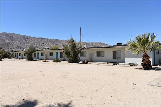 73636 Cactus Dr Unit 29, Palms, CA 92277 - rear view of house with a mountain view and stucco siding