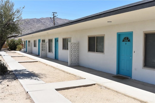 73636 Cactus Dr Unit 29, Palms, CA 92277 - view of exterior entry with a mountain view and stucco siding