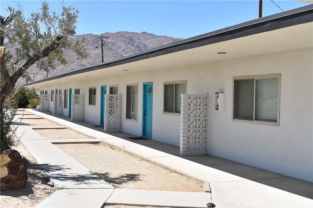 73636 Cactus Dr Unit 29, Palms, CA 92277 - view of exterior entry with a mountain view and stucco siding