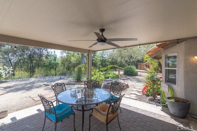 view of patio with a fenced backyard, outdoor dining area, and ceiling fan
