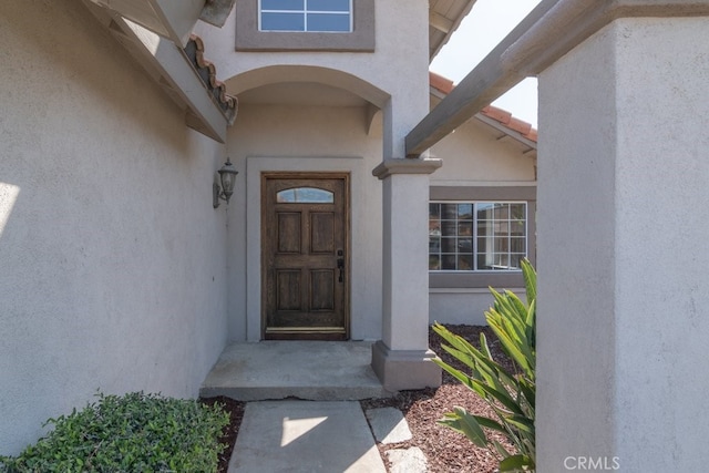 view of exterior entry featuring stucco siding