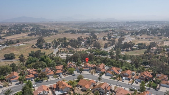 view of property location featuring a mountainous background and nearby suburban area