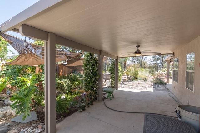 view of patio / terrace with a ceiling fan and fence