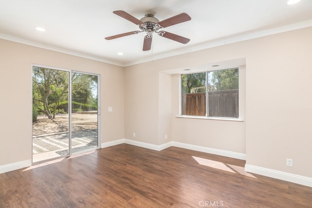 spare room with crown molding, baseboards, ceiling fan, wood finished floors, and recessed lighting