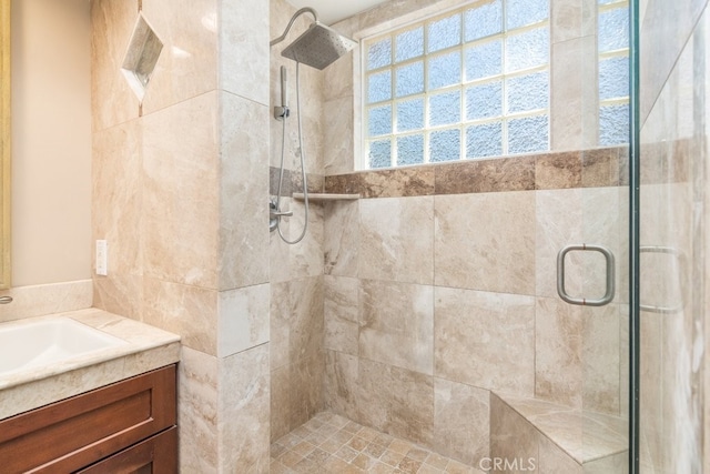 bathroom featuring a shower stall and vanity