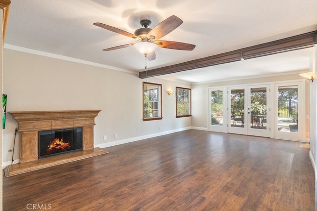 unfurnished living room featuring wood finished floors, healthy amount of natural light, a fireplace, and ornamental molding