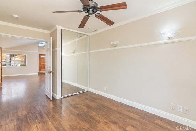 unfurnished bedroom featuring wood finished floors, baseboards, a closet, a ceiling fan, and ornamental molding