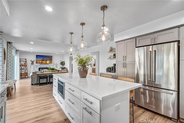 1836 Macinnes Pl, Placentia, CA 92870 - kitchen with high end fridge, open shelves, light countertops, recessed lighting, and decorative light fixtures