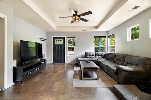 1274 Humboldt Ave, Chico, CA 95928 - living room featuring concrete flooring, a tray ceiling, baseboards, and a ceiling fan