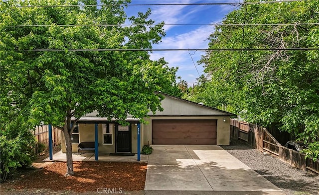 1274 Humboldt Ave, Chico, CA 95928 - view of front of property featuring an attached garage, driveway, fence, and stucco siding