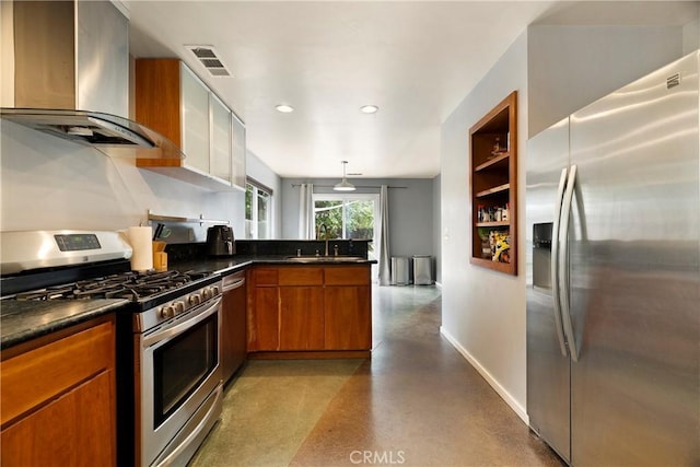 1274 Humboldt Ave, Chico, CA 95928 - kitchen featuring appliances with stainless steel finishes, wall chimney exhaust hood, brown cabinetry, a peninsula, and a sink