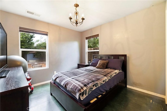 1274 Humboldt Ave, Chico, CA 95928 - bedroom featuring baseboards, finished concrete floors, and a chandelier