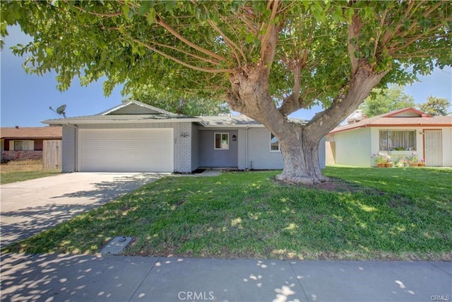 6665 Cali Ave, Winton, CA 95388 - ranch-style home featuring a garage, driveway, a front lawn, and brick siding