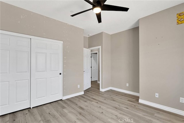 21192 Zuni Rd, Apple Valley, CA 92307 - unfurnished bedroom featuring light wood-style floors, baseboards, a closet, and a ceiling fan