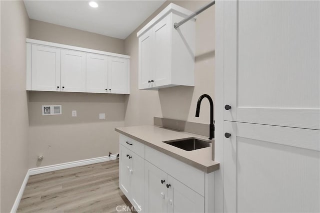 21192 Zuni Rd, Apple Valley, CA 92307 - laundry room with baseboards, washer hookup, light wood-type flooring, cabinet space, and recessed lighting