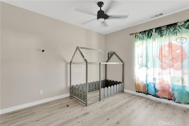 21192 Zuni Rd, Apple Valley, CA 92307 - unfurnished bedroom with wood finished floors, baseboards, and a ceiling fan
