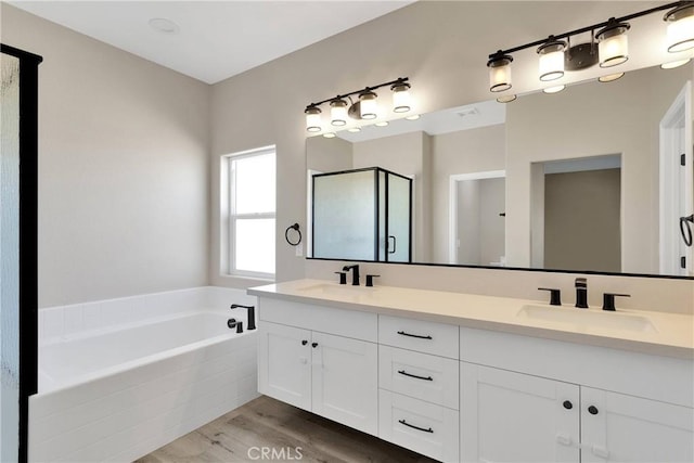 21192 Zuni Rd, Apple Valley, CA 92307 - full bathroom with double vanity, a bath, wood finished floors, and a stall shower