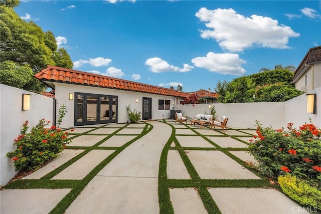 80 Seton Rd, Irvine, CA 92612 - rear view of property featuring a tiled roof, a patio area, stucco siding, and a fenced backyard
