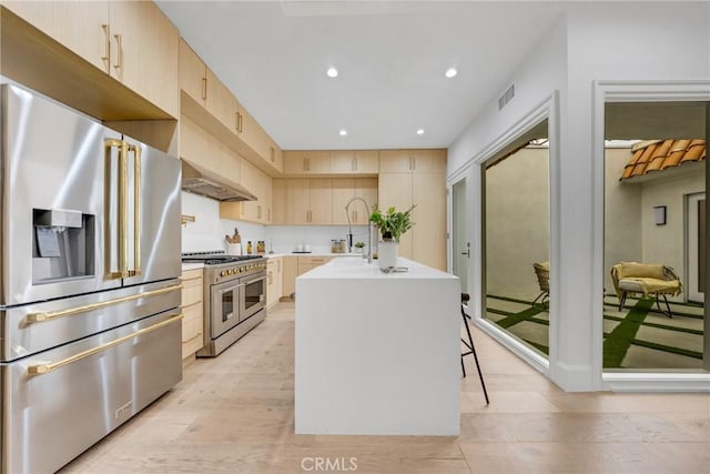80 Seton Rd, Irvine, CA 92612 - kitchen featuring premium appliances, light brown cabinetry, light countertops, light wood finished floors, and recessed lighting
