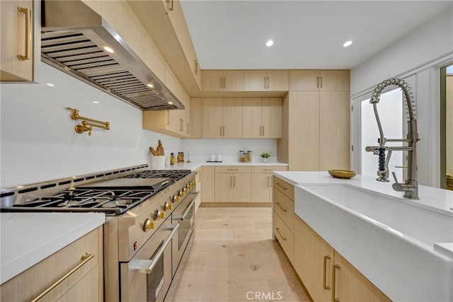 80 Seton Rd, Irvine, CA 92612 - kitchen with range with two ovens, light brown cabinetry, wall chimney exhaust hood, a sink, and light countertops