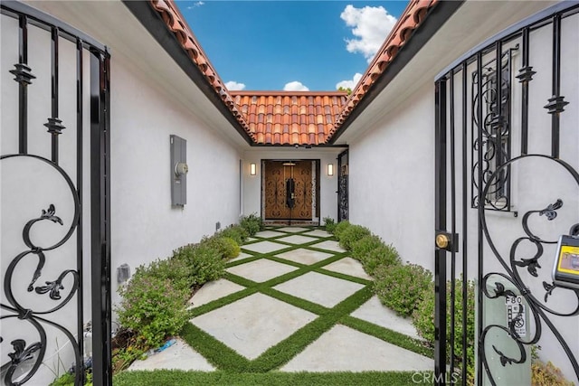 80 Seton Rd, Irvine, CA 92612 - property entrance featuring a tile roof and stucco siding
