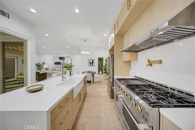 80 Seton Rd, Irvine, CA 92612 - kitchen featuring wall chimney range hood, stainless steel appliances, light brown cabinets, a sink, and light countertops