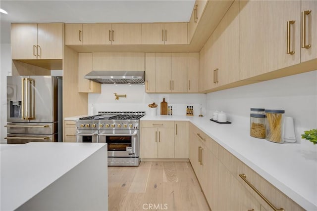 80 Seton Rd, Irvine, CA 92612 - kitchen with light brown cabinetry, appliances with stainless steel finishes, exhaust hood, light countertops, and light wood-type flooring