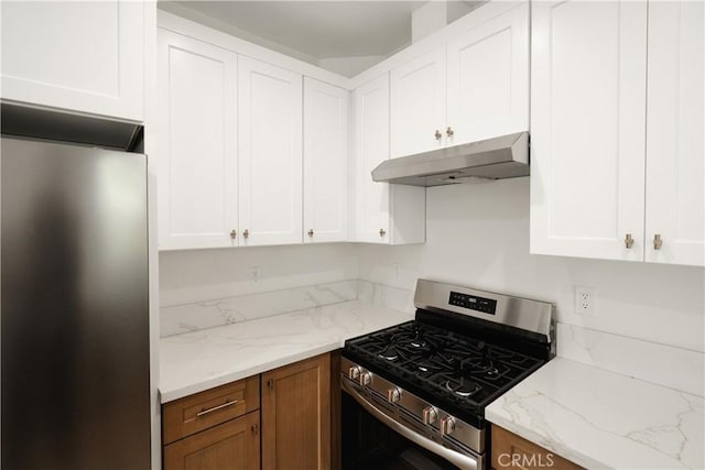 247 S Benton Way, Los Angeles, CA 90057 - kitchen with stainless steel appliances, under cabinet range hood, white cabinetry, and light stone counters