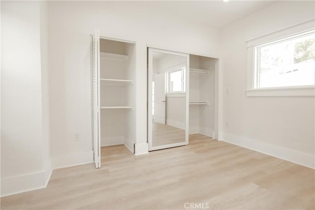 247 S Benton Way, Los Angeles, CA 90057 - unfurnished bedroom with two closets, wood finished floors, and baseboards