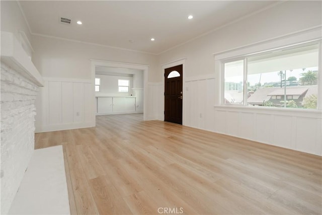 247 S Benton Way, Los Angeles, CA 90057 - unfurnished living room featuring a decorative wall, a wainscoted wall, light wood-type flooring, ornamental molding, and recessed lighting